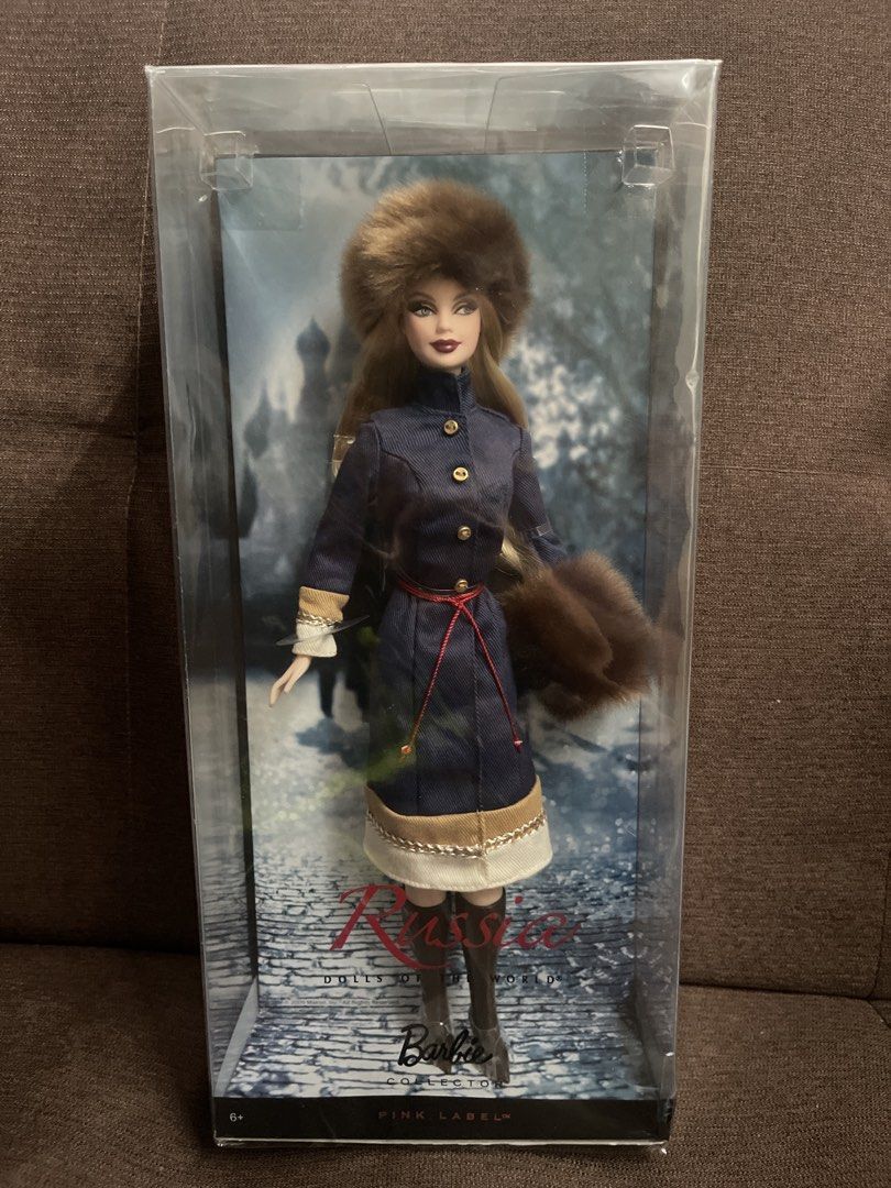 Barbie Russia Doll Pink Label (Category: Kids Toys) located in Manila. Submitted by helllodollie (Listing ID 1422738156, Image 1). Description: - Barbie doll from the Pink Label collection. - Features a winter-themed outfit. - Includes a blue coat with gold buttons. - Comes with a fur hat and brown boots. - Doll is in original packaging. - Packaging features a snowy background. - Box includes the Barbie logo and the word "Russia"..