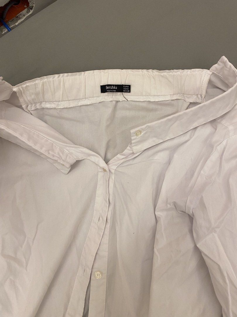 Bershka White Off-Shoulder Shirt (Category: Shirts) located in Mandaluyong City. Submitted by weakassbitch (Listing ID 1422816372, Image 3). Description: - 8/10 condition - Size: S - Tie detail at cuffs - Button-down front .