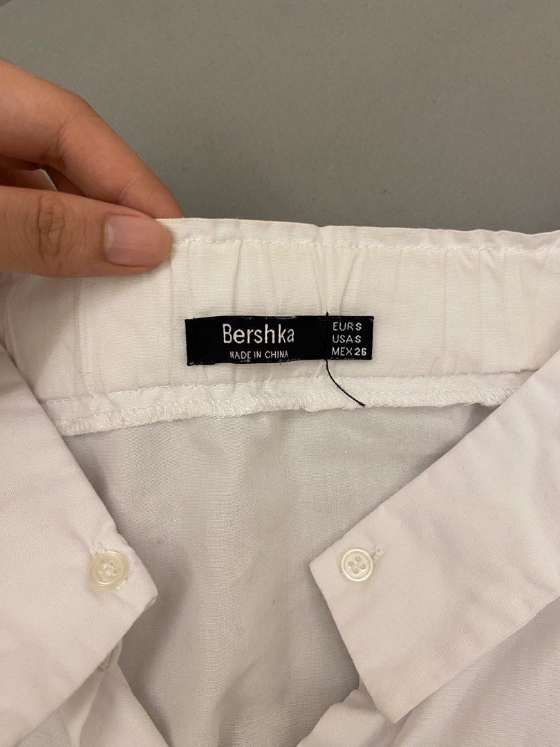 Bershka White Off-Shoulder Shirt (Category: Shirts) located in Mandaluyong City. Submitted by weakassbitch (Listing ID 1422816372, Image 2). Description: - 8/10 condition - Size: S - Tie detail at cuffs - Button-down front .