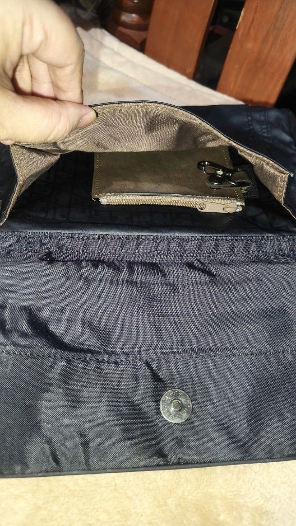 Black Messenger Bag with Multiple Compartments (Category: Sling Bags) located in Tanza. Submitted by declutterolshoppe (Listing ID 1422826572, Image 3). Description: - Black messenger bag - Adjustable shoulder strap - Multiple compartments for organization - Front pocket for easy access - Interior pockets for valuables - Secure flap closure with snap button - Front zipper pocket - Durable, long-lasting material - Stylish design with a lighter bro