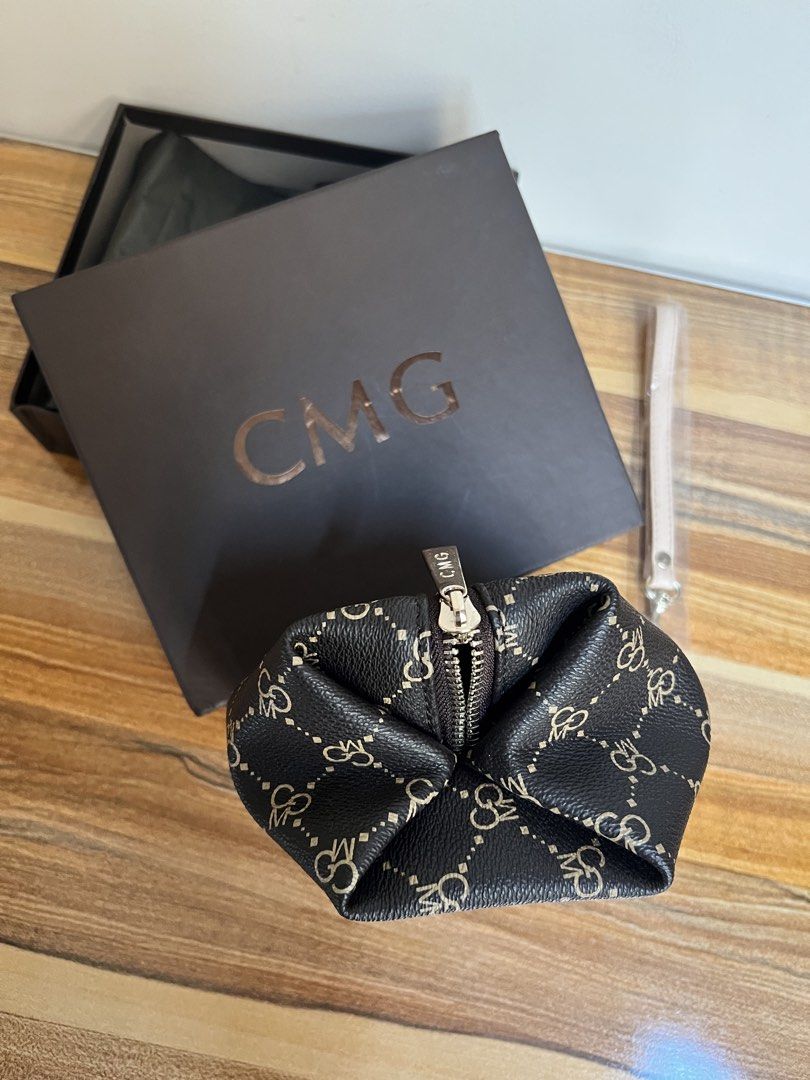 Brand new CMG Pouch with Wrist Strap (Category: Purses & Pouches) located in Quezon City. Submitted by spontaneousgrace (Listing ID 1422787644, Image 3). Description: CMG pouch with a stylish pattern - Secure zipper closure - Comes with a matching wrist strap - Includes original box - Clean interior - Perfect for organizing essentials or as a chic accessory - Great to give as a gift! Condition: Brand New. Never used.