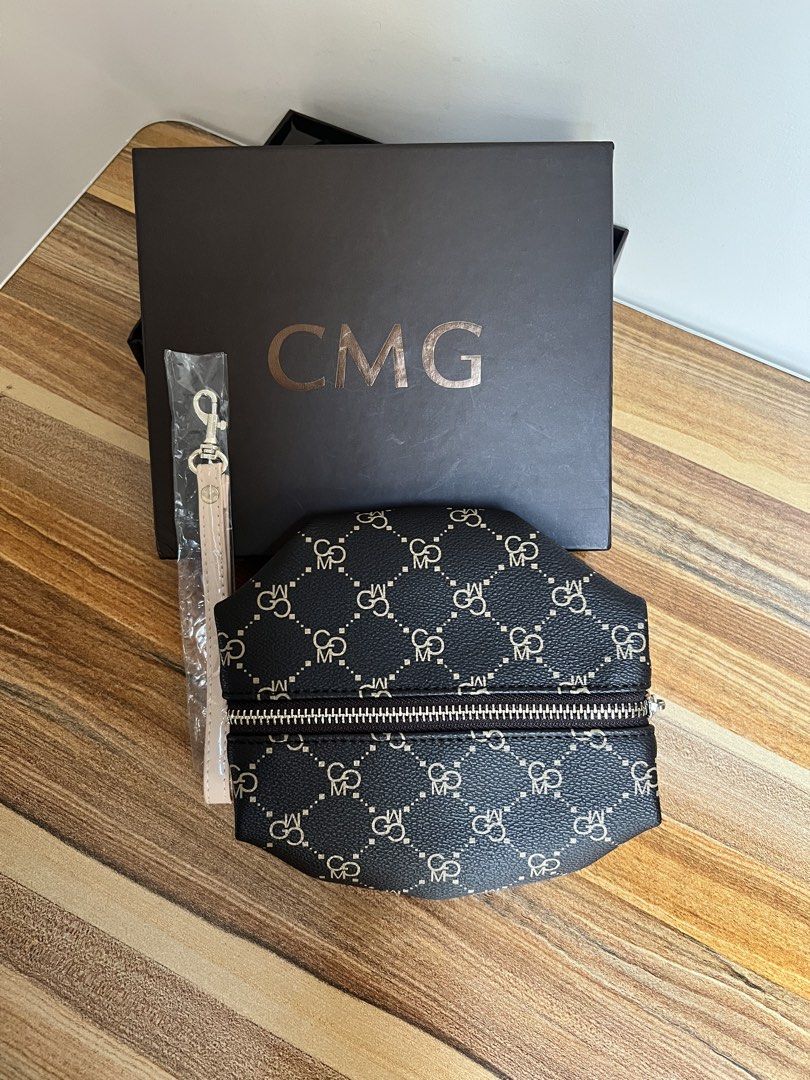 Brand new CMG Pouch with Wrist Strap (Category: Purses & Pouches) located in Quezon City. Submitted by spontaneousgrace (Listing ID 1422787644, Image 2). Description: CMG pouch with a stylish pattern - Secure zipper closure - Comes with a matching wrist strap - Includes original box - Clean interior - Perfect for organizing essentials or as a chic accessory - Great to give as a gift! Condition: Brand New. Never used.