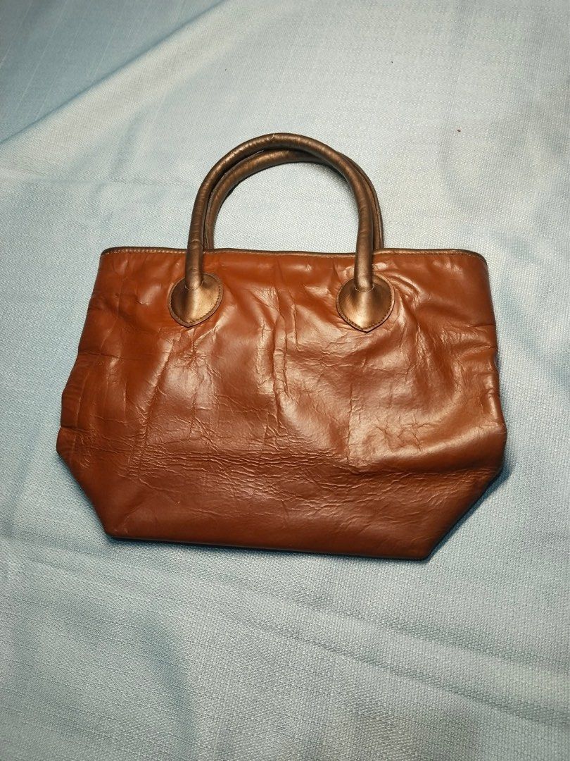Brown Leather Handbag with Gold Handles (Category: Luxury Bags & Wallets) located in Malabon City. Submitted by lunapie (Listing ID 1422723191, Image 1). Description: - Brown leather handbag - Gold-colored handles - Rectangular shape - Structured base - Top handle design - Textured leather finish - Approximately 14 inches in length.