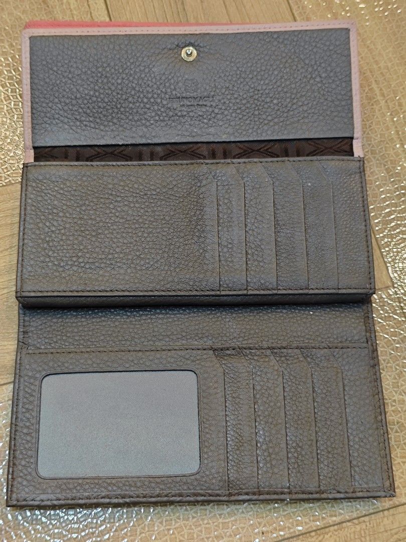 Bruno Magli Leather Wallet (Category: Luxury Bags & Wallets) located in San Miguel. Submitted by mharly0221 (Listing ID 1422898653, Image 1). Description: - Bruno Magli bi-fold wallet - Multiple card slots - Clear ID window - Zippered compartment - Patterned interior lining - Textured leather exterior - Snap closure - Color combination: Red, black, and gray.