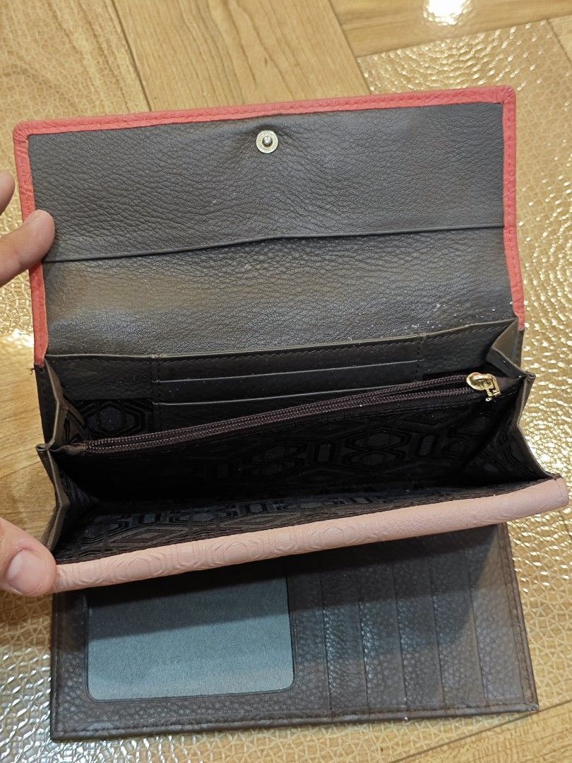 Bruno Magli Leather Wallet (Category: Luxury Bags & Wallets) located in San Miguel. Submitted by mharly0221 (Listing ID 1422898653, Image 3). Description: - Bruno Magli bi-fold wallet - Multiple card slots - Clear ID window - Zippered compartment - Patterned interior lining - Textured leather exterior - Snap closure - Color combination: Red, black, and gray.