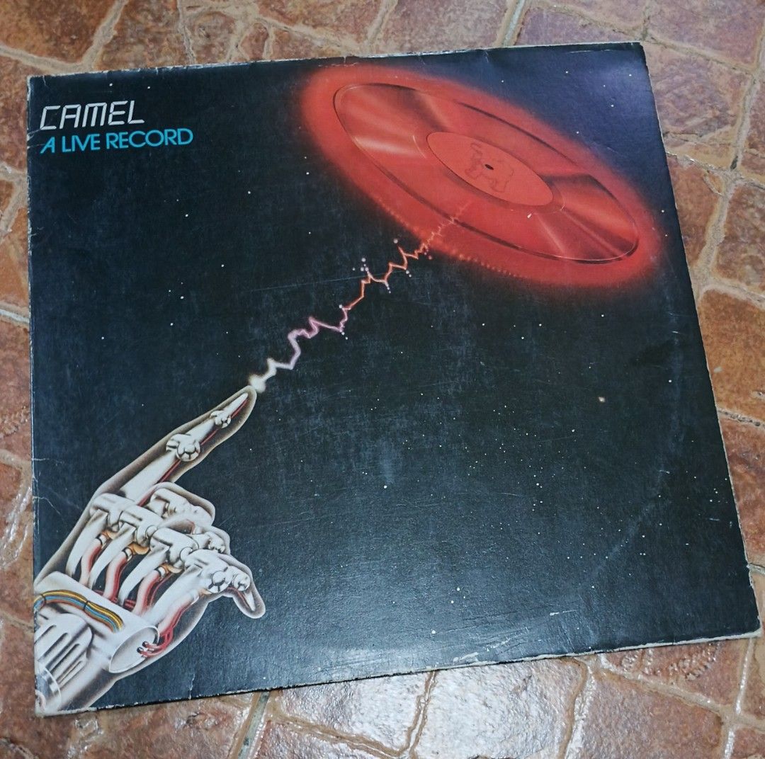Camel - A Live Record Vinyl LP (Category: Vinyls) located in Quezon City. Submitted by dancatz (Listing ID 1422867047, Image 1). Description: •P 1,500.00 • mint condition [ vinyl and cover sleeve - Camel 'A Live Record' vinyl LP - Features tracks: 'Never Let Go', 'Lady Fantasy', 'The Snow Goose' - Nova Records release - Album art: Futuristic design with robotic hand and glowing record - Back cover: Tracklist included - Includes original sleeve LF