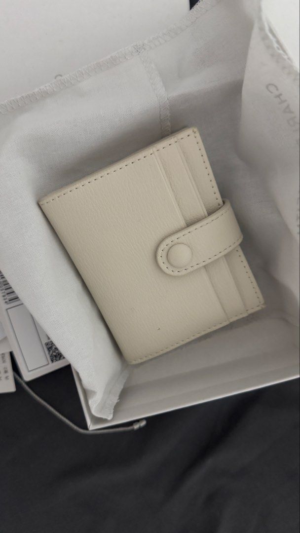Charles & Keith Bliss Snap Button Card Holder (Category: Wallets & Card holders) located in Rizal. Submitted by marispreloved (Listing ID 1422857608, Image 2). Description: - Charles & Keith card holder wallet - Color: Beige - Features: - Multiple card slots - Snap closure - Includes: - Original box - Dust bag - Tags - Size: XXS - Authentic Charles & Keith logo visible.