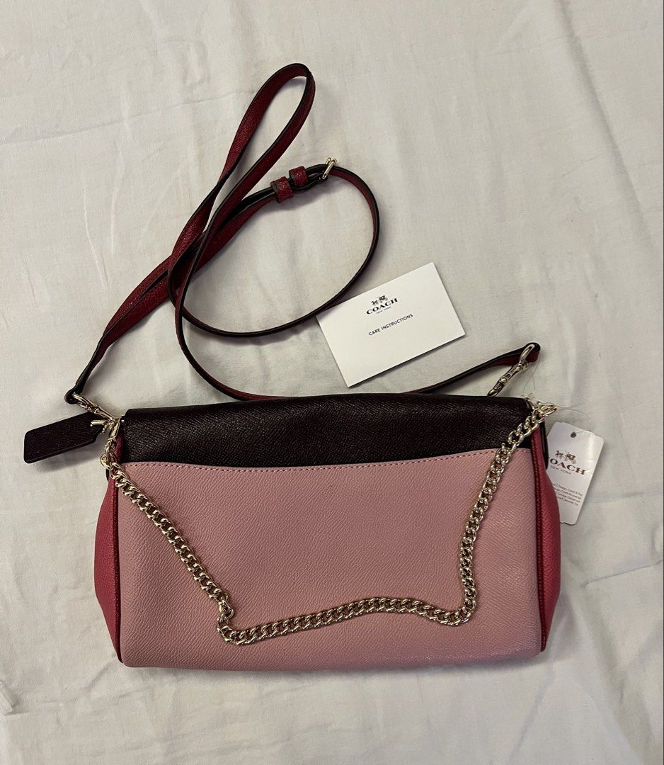 Coach Colorblock Chain Crossbody Bag Ruby (Category: Luxury Bags & Wallets) located in Quezon City. Submitted by spontaneousgrace (Listing ID 1422794779, Image 2). Description: Coach crossbody bag - Colorblock design: pink and burgundy - Chain strap - Detachable leather strap - Includes Coach hangtag - Includes care instructions - Interior: zip pocket and slip pocket Condition: Brand New, never used. But there is some ‘bakbak’ on the tag inside. 