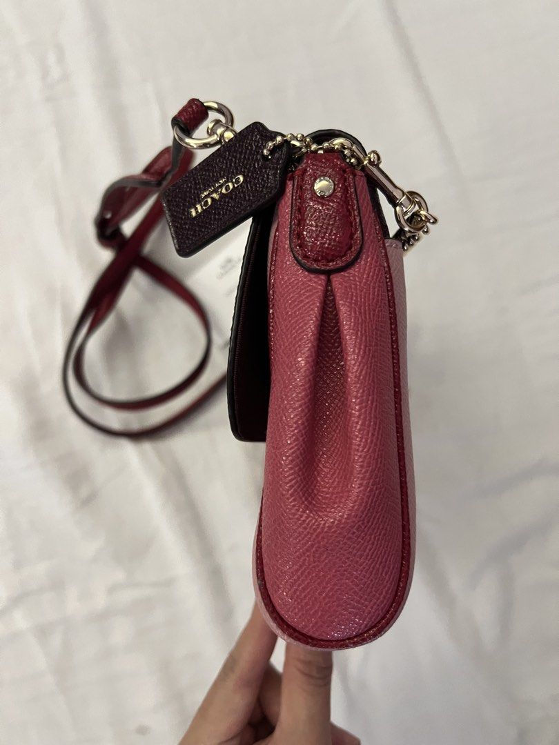 Coach Colorblock Chain Crossbody Bag Ruby (Category: Luxury Bags & Wallets) located in Quezon City. Submitted by spontaneousgrace (Listing ID 1422794779, Image 3). Description: Coach crossbody bag - Colorblock design: pink and burgundy - Chain strap - Detachable leather strap - Includes Coach hangtag - Includes care instructions - Interior: zip pocket and slip pocket Condition: Brand New, never used. But there is some ‘bakbak’ on the tag inside. 