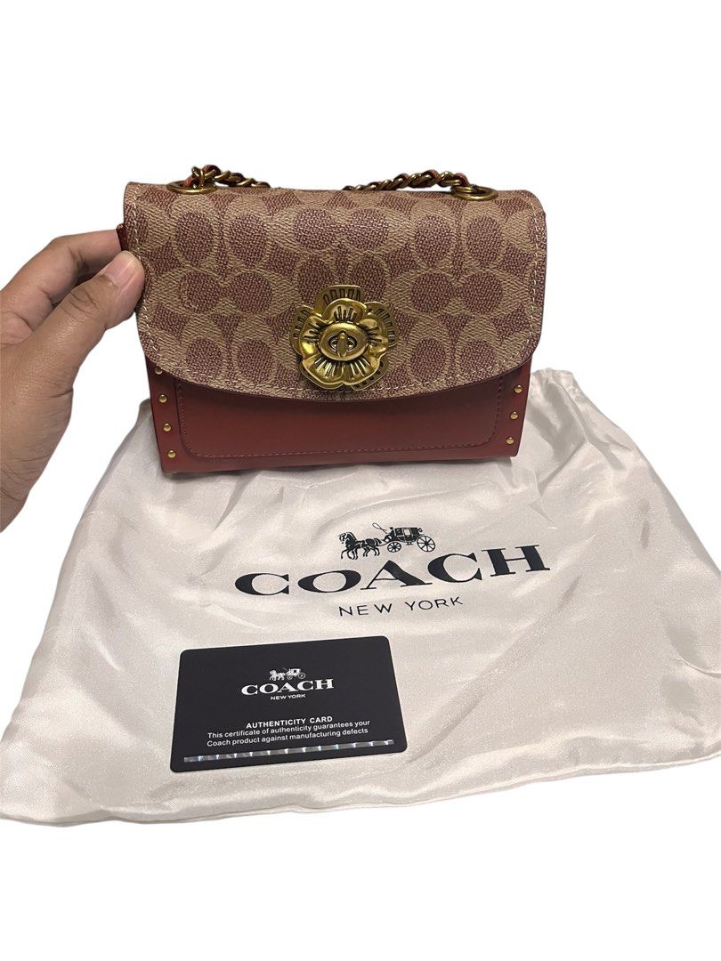 Coach Parker 18 (Category: Luxury Bags & Wallets) located in Malabon City. Submitted by jammiestjam (Listing ID 1422783828, Image 2). Description: - Authentic Coach crossbody bag - Floral clasp detail - Elegant chain strap - Exterior: Signature Coach pattern with burgundy color - Interior: Deep burgundy lining - Includes dust bag and authenticity card - Compact size, perfect for essentials.