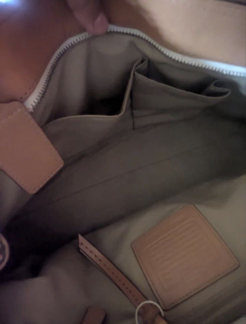 Coach Pleated Soho Tote Bag (Category: Luxury Bags & Wallets) located in Manila. Submitted by niniip (Listing ID 1422868156, Image 2). Description: -Authentic Coach Soho Pleated Tote -Need Wash may stain -Decluttering -One of my fave bags •Dimensions: Approximately 14”-18” (L) × 11” (H) × 4”-5.5” (D). • Interior Features: Typically includes a three-compartment design with a large central zippered divider, an additional interior zip pocket, and tw