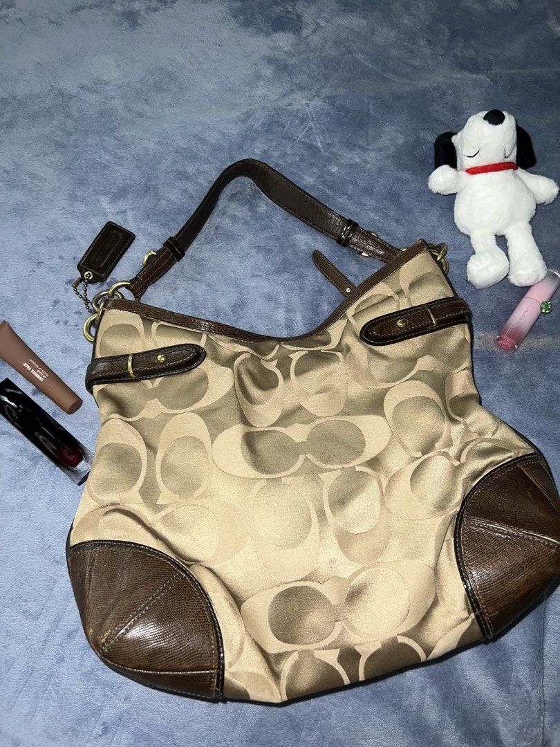 Coach Signature Hobo Bag (Category: Luxury Bags & Wallets) located in Quezon City. Submitted by declutter.ph4 (Listing ID 1422751086, Image 2). Description: - Coach Signature Hobo Bag - Classic design with signature pattern - Brown leather trim and handle - Spacious interior - Includes Coach hangtag DM for more info :).