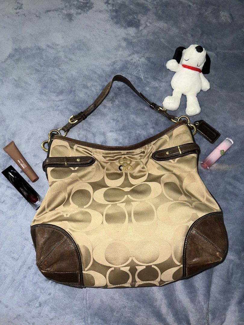 Coach Signature Hobo Bag (Category: Luxury Bags & Wallets) located in Quezon City. Submitted by declutter.ph4 (Listing ID 1422751086, Image 1). Description: - Coach Signature Hobo Bag - Classic design with signature pattern - Brown leather trim and handle - Spacious interior - Includes Coach hangtag DM for more info :).