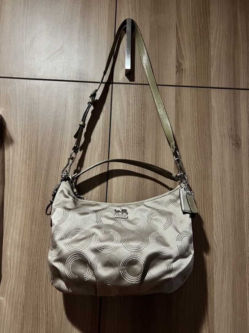 Coach Signature Hobo Bag (Category: Luxury Bags & Wallets) located in Quezon City. Submitted by spontaneousgrace (Listing ID 1422811602, Image 3). Description: Coach signature hobo bag - Neutral color - Circular pattern design - Teal interior lining - Multiple compartments - Adjustable shoulder strap - Includes matching dust bag - Coach leather tag inside Condition: Barely Used.