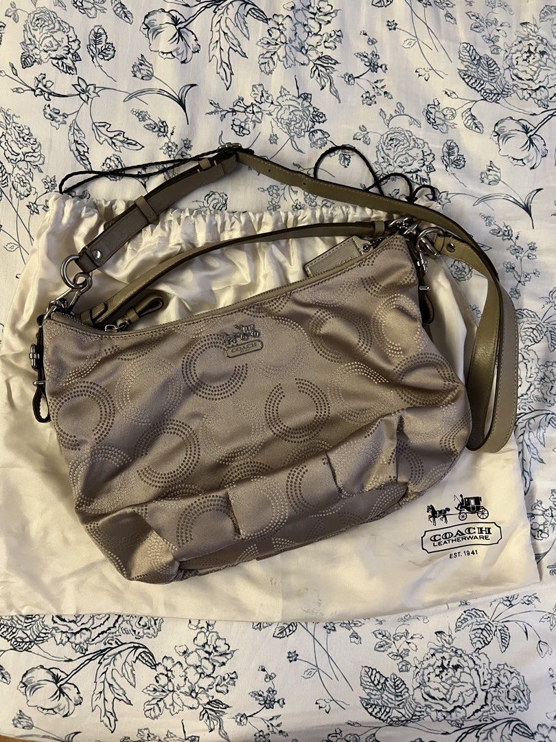 Coach Signature Hobo Bag (Category: Luxury Bags & Wallets) located in Quezon City. Submitted by spontaneousgrace (Listing ID 1422811602, Image 1). Description: Coach signature hobo bag - Neutral color - Circular pattern design - Teal interior lining - Multiple compartments - Adjustable shoulder strap - Includes matching dust bag - Coach leather tag inside Condition: Barely Used.