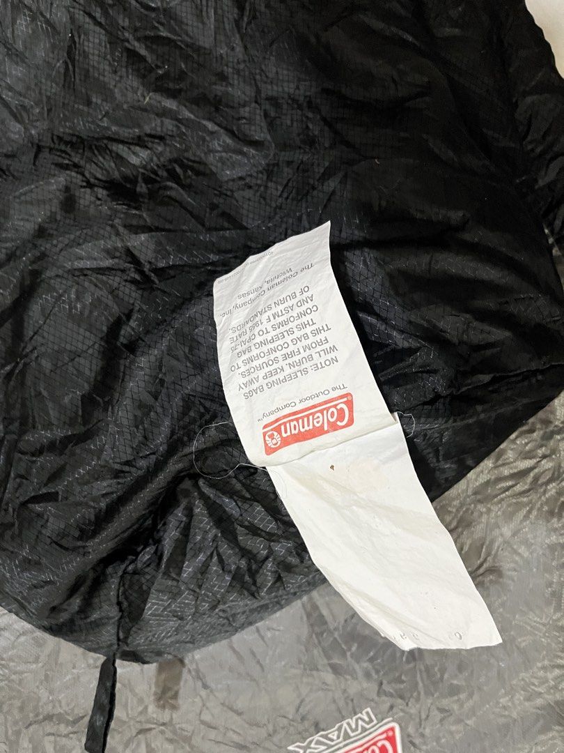 Coleman MAX Sleeping Bag (Category: Hiking & Camping) located in Batangas. Submitted by seiferdg (Listing ID 1422814502, Image 3). Description: - Coleman MAX sleeping bag - Black and gray color scheme - Features a zipper closure - Includes care instructions tag - Ideal for camping and outdoor activities.