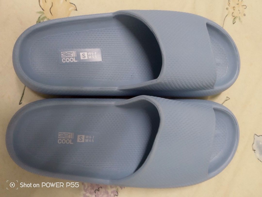 Cool Slides - Blue (Category: Slippers and slides) located in Binan City. Submitted by stuffshop29 (Listing ID 1422823140, Image 3). Description: Light blue slides. Features a textured footbed and sole for grip. The sole has a size marking of 'S'. Made in China. The slides have a simple, open-toe design. The brand name 'Cool' is visible on the footbed..
