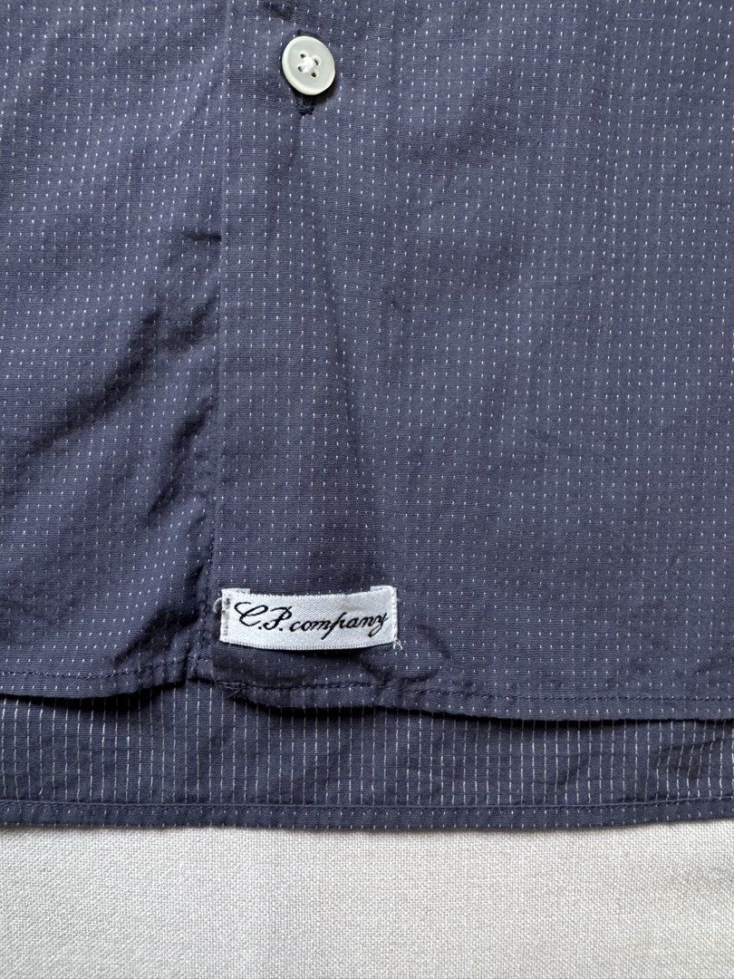 CP Company Shirt (Category: Shirts) located in Singapore. Submitted by mangosteeeeen (Listing ID 1422830540, Image 3). Description: C.P. COMPANY DOT NAVY SHIRT DESIGNED BY MASSIMO OSTI, FOUNDER OF STONE ISLAND BEAUTIFUL STICHING WORK AROUND THE SHIRT SIZE 3 FITS A LARGE .