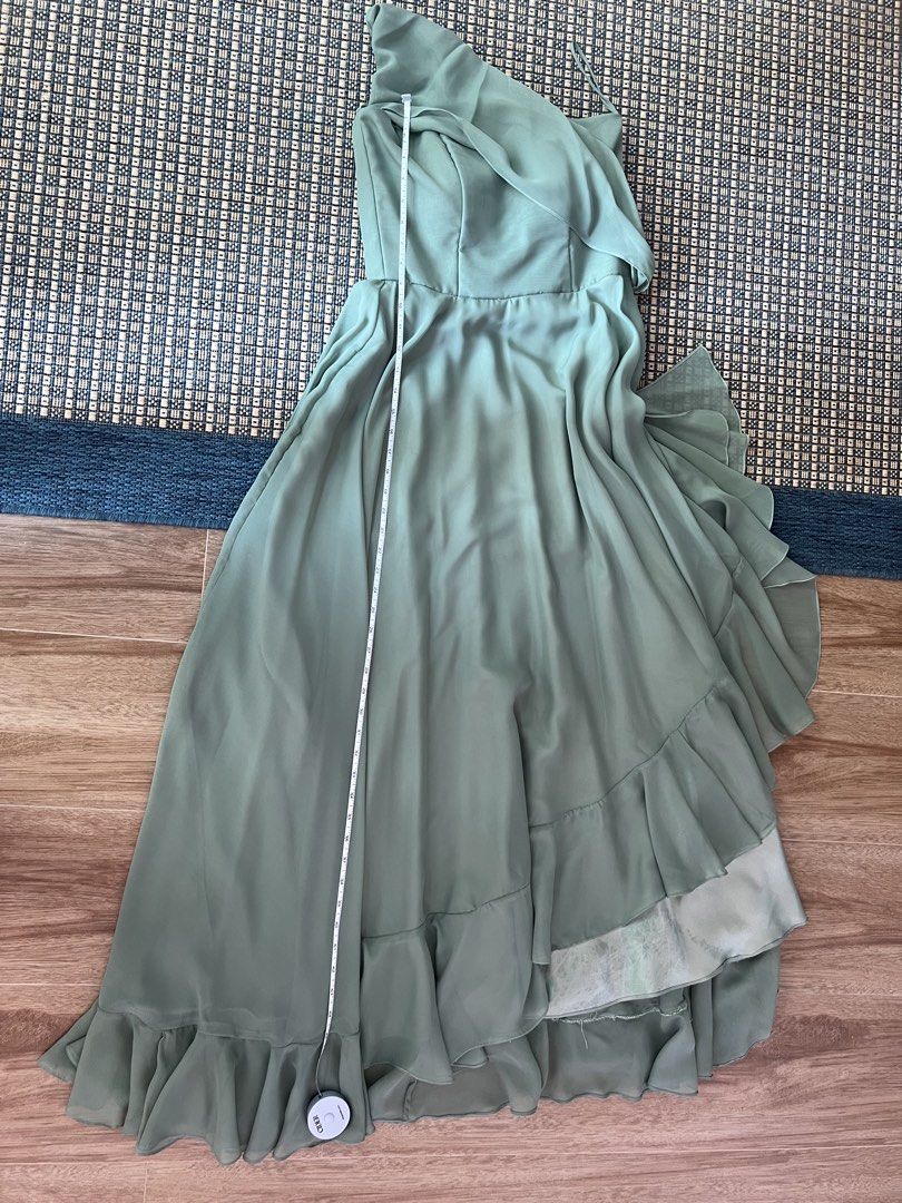 (Custom gown) Sage Green One-Shoulder (Category: Dresses) located in Taguig. Submitted by new_again_ (Listing ID 1422769771, Image 2). Description: - Elegant sage green maxi dress - One-shoulder design with asymmetrical overlay - Fitted bodice - Flowing skirt with high-low hemline - Includes delicate spaghetti strap - Made of lightweight, flowing fabric - Ideal for special occasions.