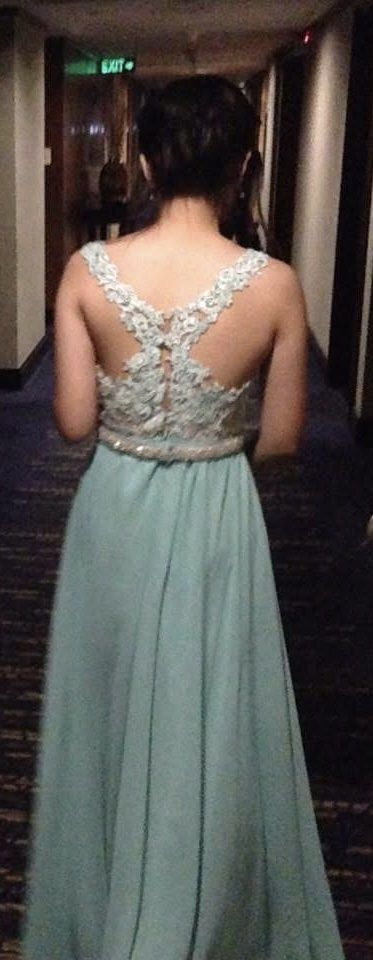 Mint Green Lace Embellished Gown (Category: Evening dresses & gowns) located in San Pedro. Submitted by mighty_oh (Listing ID 1422770333, Image 1). Description: Elegant mint green gown with intricate lace detailing. Features a sheer neckline and back with delicate beadwork. The bodice is embellished with lace and pearls, and the dress has a flowing, floor-length skirt. Perfect for formal events or special occasions. The dress has a fitted bodice 