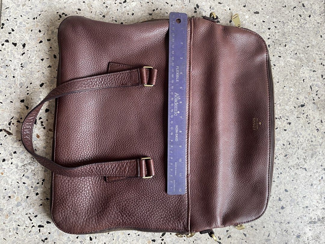 Fossil brown leather satchel (Category: Luxury Bags & Wallets) located in Quezon City. Submitted by liama (Listing ID 1422727736, Image 2). Description: Classic brown soft leather Tote for laptop, books, papers Zipper, also has expandable zipper Brass detail <BDO/Metrobank; buyer books/pays for pickup>.