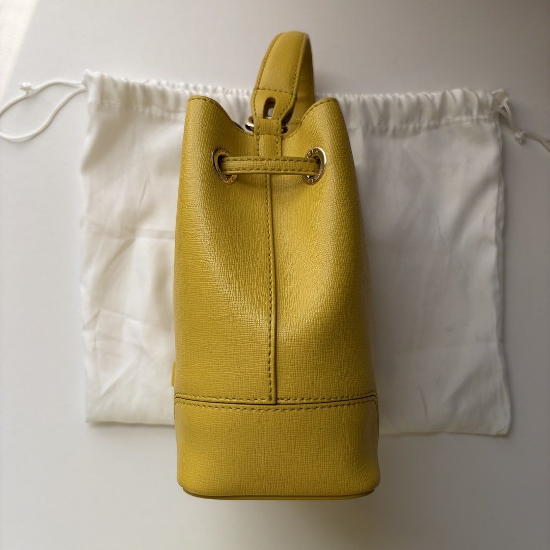 furla bucket bag yellow (Category: Luxury Bags & Wallets) located in Bacoor. Submitted by hyuckshaul (Listing ID 1422722991, Image 2). Description: furla yellow bucket bag - preloved, got this from another seller so do manage expectations - can send more photos if needed - meetups possible - rfs: not using mop: gcash, maya, bank transfers.