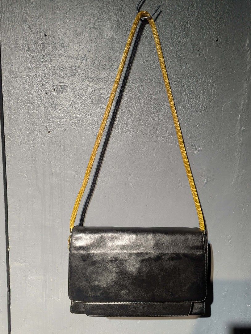 Gianni Versace Black Leather Shoulder Bag (Category: Luxury Bags & Wallets) located in Manila. Submitted by roblesniks33584 (Listing ID 1422747649, Image 1). Description: - Gianni Versace shoulder bag - Black leather - Gold-toned chain strap - Decorative charm - Flap closure - Fabric lining - High-quality leather - Classic and stylish.