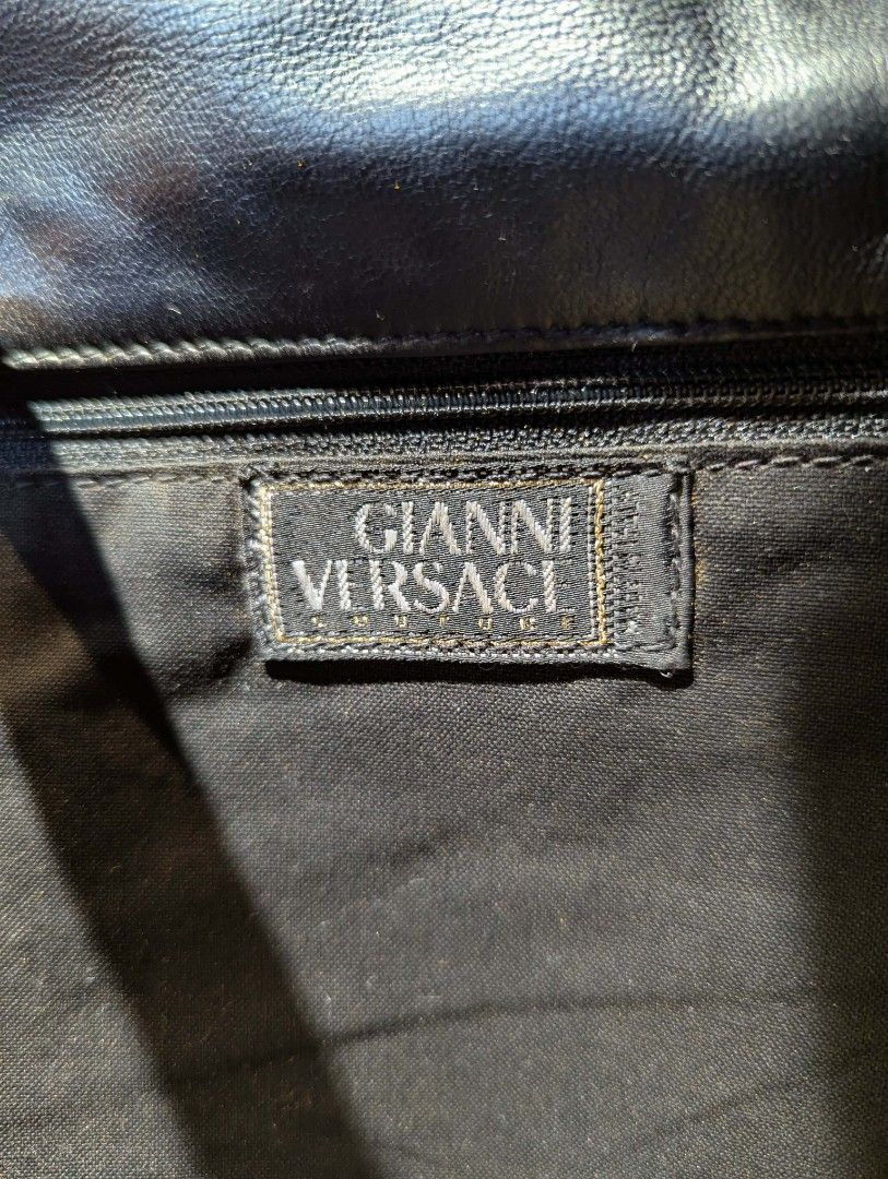 Gianni Versace Black Leather Shoulder Bag (Category: Luxury Bags & Wallets) located in Manila. Submitted by roblesniks33584 (Listing ID 1422747649, Image 2). Description: - Gianni Versace shoulder bag - Black leather - Gold-toned chain strap - Decorative charm - Flap closure - Fabric lining - High-quality leather - Classic and stylish.