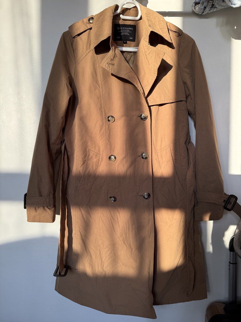 Giordano Trench Coat Brown (Category: Coats, Jackets and Outerwear) located in Pasig City. Submitted by helpmedispose (Listing ID 1422809362, Image 1). Description: - Giordano trench coat - Classic double-breasted style - Includes belt - Button details on sleeves - Neutral color - Versatile for different outfits.