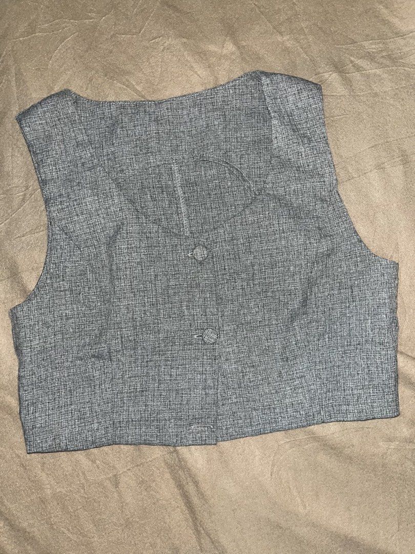 Gray Vest with Buttons (Category: Sleeveless) located in Manila. Submitted by quarishop21 (Listing ID 1422827199, Image 1). Description: - Gray vest - Classic two-button design - V-neck - Cropped length - Textured weave fabric - Versatile for different outfits.