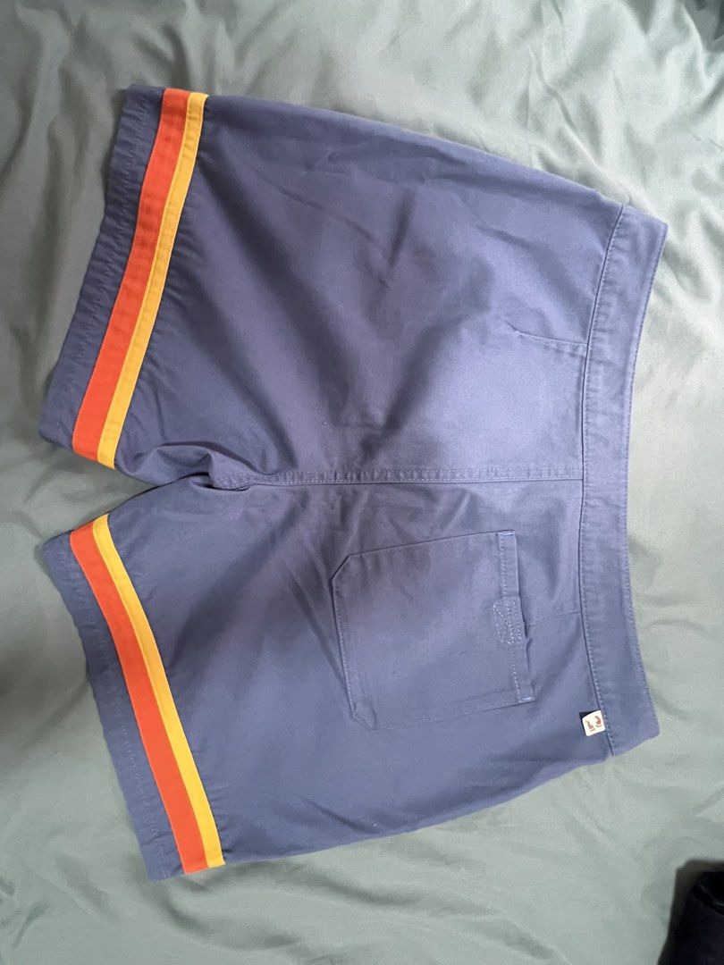 Hang Ten Blue Shorts with Stripes (Category: Swim Trunks & Board Shorts) located in Dasmarinas. Submitted by kelcastillo (Listing ID 1422750204, Image 1). Description: - Hang Ten shorts - Size 32 - Blue with orange and yellow side stripes - Back pocket - Drawstring closure - Small Hang Ten logo - Durable material.