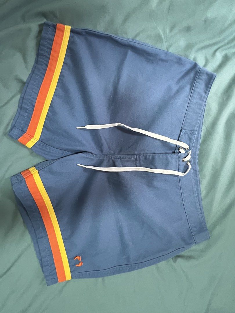 Hang Ten Blue Shorts with Stripes (Category: Swim Trunks & Board Shorts) located in Dasmarinas. Submitted by kelcastillo (Listing ID 1422750204, Image 2). Description: - Hang Ten shorts - Size 32 - Blue with orange and yellow side stripes - Back pocket - Drawstring closure - Small Hang Ten logo - Durable material.
