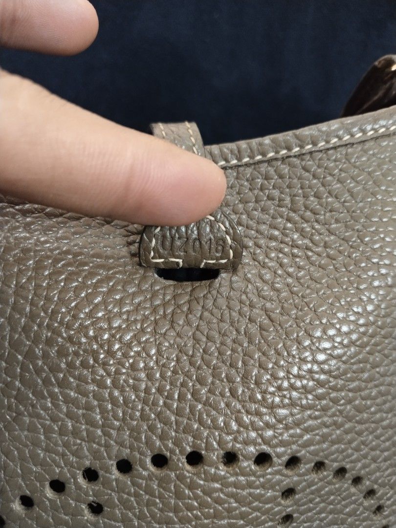 Hermes evelyn TPM Bag (Category: Luxury Bags & Wallets) located in Bayombong. Submitted by rnstrifty (Listing ID 1422856455, Image 3). Description: - not sure on authenticity - Neutral color - Iconic 'H' perforation detail - Flap closure with button - Interior visible in photos - Made in France.