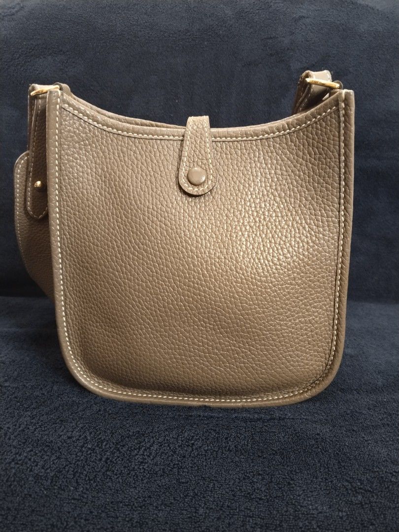 Hermes evelyn TPM Bag (Category: Luxury Bags & Wallets) located in Bayombong. Submitted by rnstrifty (Listing ID 1422856455, Image 2). Description: - not sure on authenticity - Neutral color - Iconic 'H' perforation detail - Flap closure with button - Interior visible in photos - Made in France.