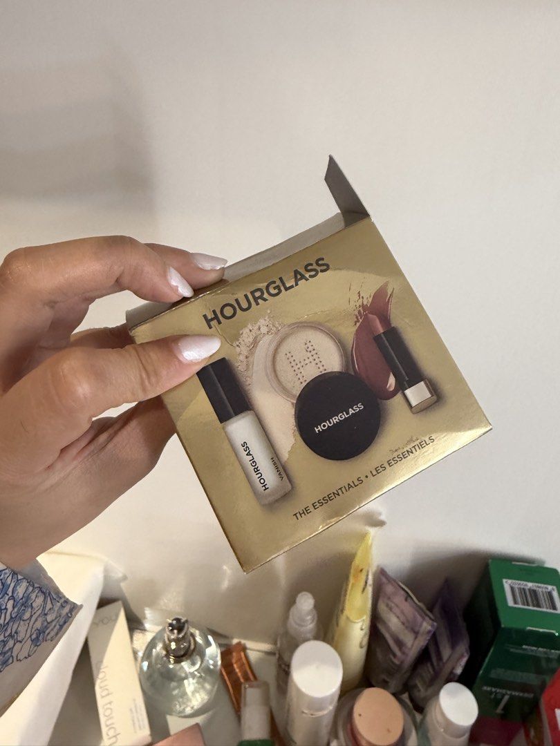 Hourglass The Essentials Set (Category: Makeup) located in Quezon City. Submitted by destashingmycloset (Listing ID 1422859910, Image 1). Description: - Hourglass The Essentials Set - Includes: - Primer - Setting Powder - Blush - Lipstick - Comes in a gold box with Hourglass logo. - Ideal for travel or trying Hourglass products..