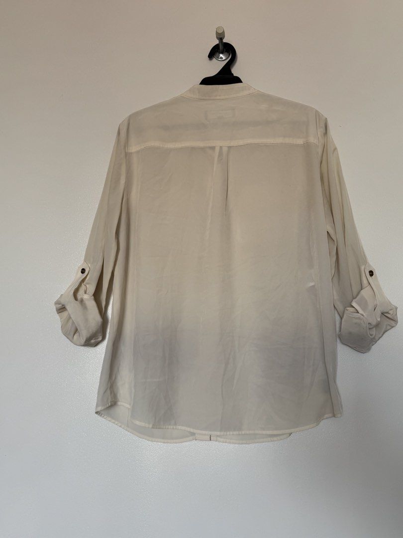 Jones New York cream polo (Category: Longsleeves) located in Makati City. Submitted by pattystuff (Listing ID 1422776330, Image 2). Description: - Cream longsleeves with Henley collar and sleeve tabs - Silky material - Needs washing - Pre-loved, please manage expectations.