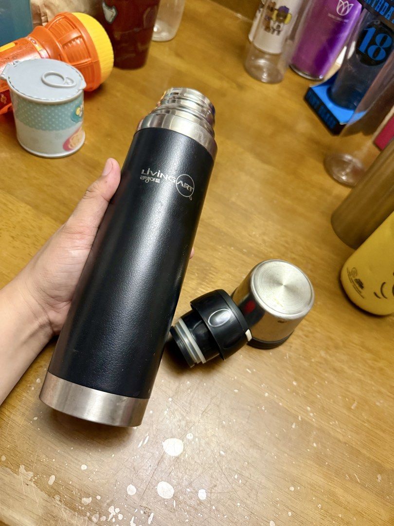 Living Art Thermos (Category: Coffee & Tea Tableware) located in Pilar. Submitted by faveanyshop (Listing ID 1422788116, Image 2). Description: - Living Art thermos - Black body with silver top and bottom - Push-button lid - Clean interior - Korean text on the bottom - Keeps drinks hot or cold.