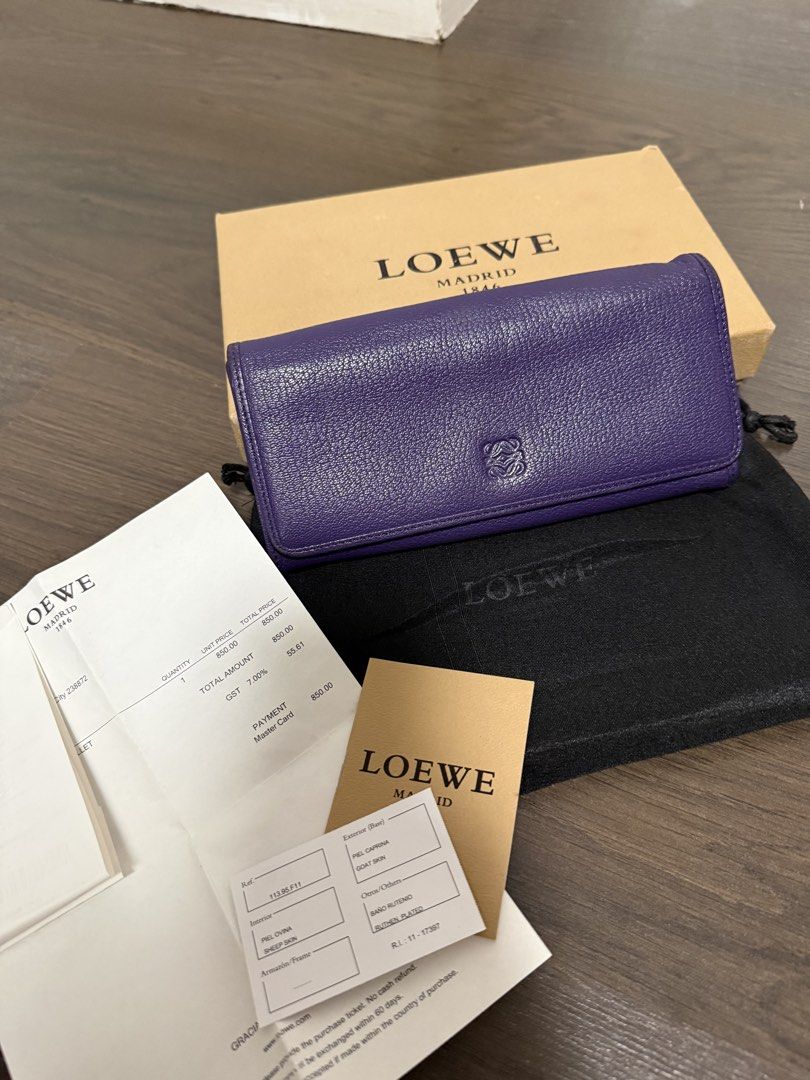 Loewe Leather Wallet (Category: Luxury Bags & Wallets) located in Pasig City. Submitted by poppyseed_finds (Listing ID 1422818973, Image 1). Description: - Authentic Loewe wallet - Vibrant purple color - Zip-around closure - Multiple card and cash compartments - Includes original box, dust bag, receipt and authenticity cards - Subtly embossed Loewe logo - Black leather interior - Well-maintained condition - Ruthen Plated - sheep skin interior/goa