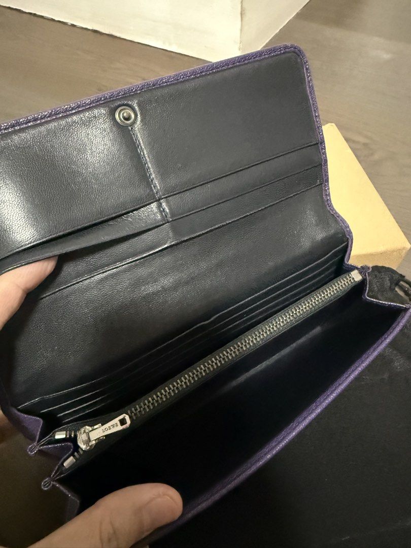 Loewe Leather Wallet (Category: Luxury Bags & Wallets) located in Pasig City. Submitted by poppyseed_finds (Listing ID 1422818973, Image 3). Description: - Authentic Loewe wallet - Vibrant purple color - Zip-around closure - Multiple card and cash compartments - Includes original box, dust bag, receipt and authenticity cards - Subtly embossed Loewe logo - Black leather interior - Well-maintained condition - Ruthen Plated - sheep skin interior/goa