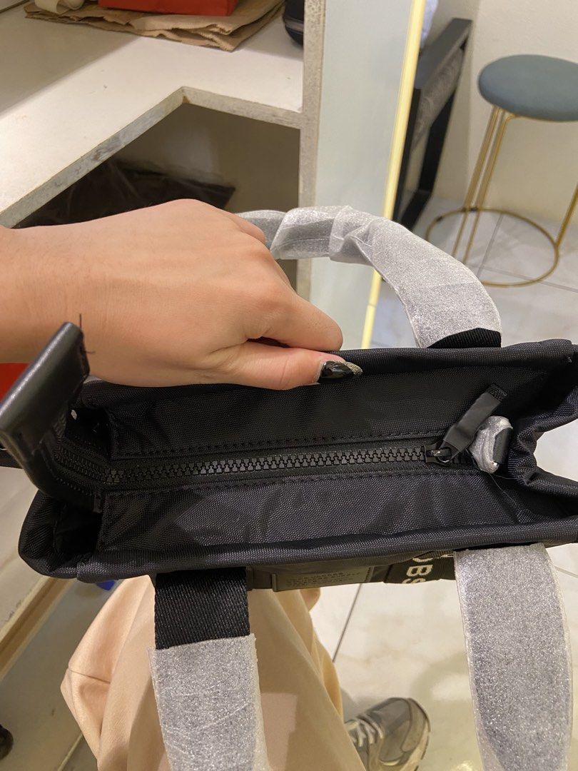 Marc Jacobs Mini Tote Bag Black (Category: Luxury Bags & Wallets) located in Agdangan. Submitted by happytree_phoenix (Listing ID 1422773776, Image 3). Description: - Authentic Marc Jacobs Mini Tote Bag - Color: Black - Features top zip closure - Includes two top handles with brand name print - Brand tag included - Condition: New and unused.