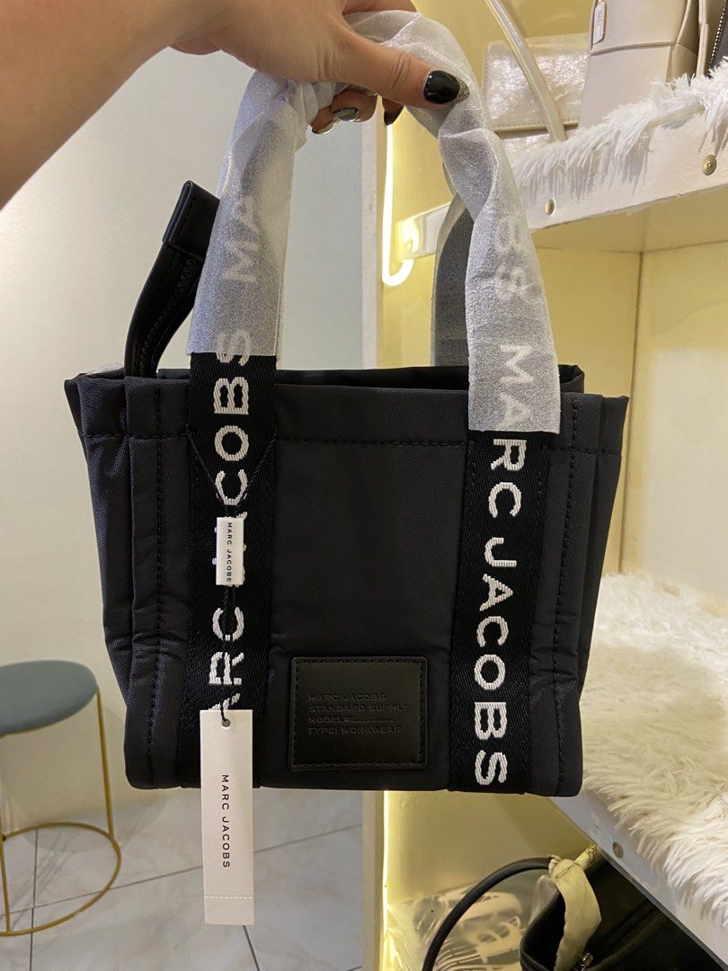 Marc Jacobs Mini Tote Bag Black (Category: Luxury Bags & Wallets) located in Agdangan. Submitted by happytree_phoenix (Listing ID 1422773776, Image 1). Description: - Authentic Marc Jacobs Mini Tote Bag - Color: Black - Features top zip closure - Includes two top handles with brand name print - Brand tag included - Condition: New and unused.