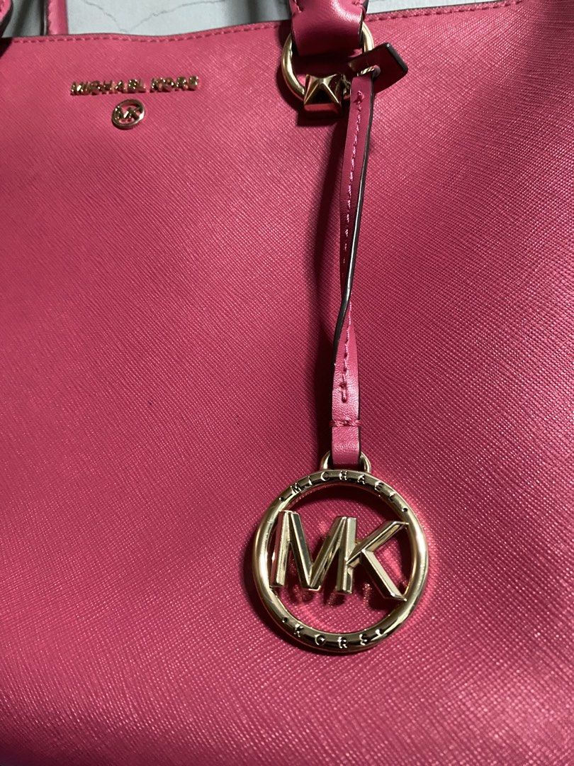 Michael Kors Pink Satchel Handbag (Category: Luxury Bags & Wallets) located in Manila. Submitted by missthrift___ (Listing ID 1422898870, Image 2). Description: - Authentic Michael Kors satchel handbag - Color: Pink - Top handle design - Gold-tone hardware - Detachable MK charm - Interior: Zip pocket - Closure: Zip and magnetic - Protective metal feet at the bottom - issue indicated last pic (9th slide).