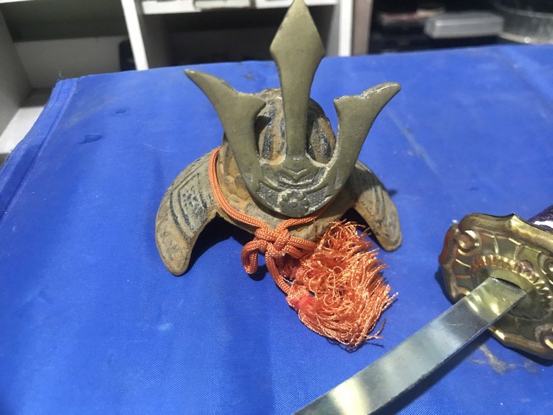 Miniature Samurai Sword with Helmet (Category: Vintage Collectibles) located in Santo Tomas. Submitted by retrotastic (Listing ID 1422734085, Image 2). Description: Mini gold toned katana and samurai headgear .