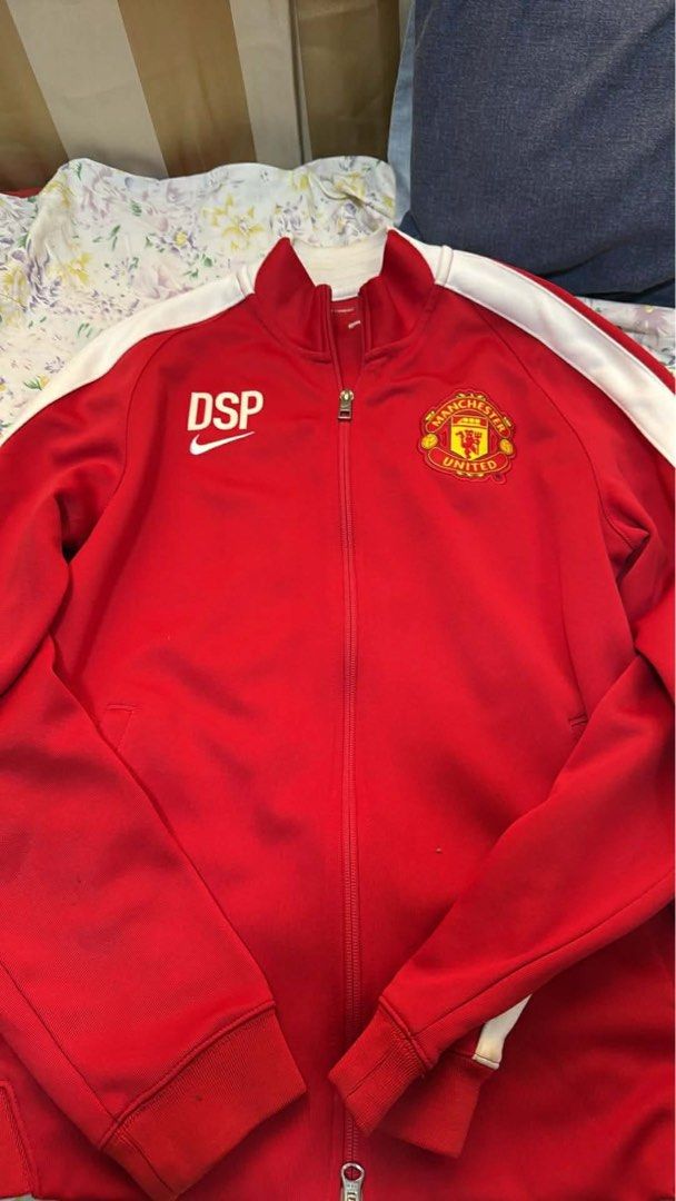 Nike Manchester United Track Jacket (Category: Coats, Jackets and Outerwear) located in Manila. Submitted by jepandan (Listing ID 1422805746, Image 2). Description: - Manchester United track jacket - Red color with white stripes on sleeves - Nike logo on chest - Full zip closure - High collar - "DSP" printed on chest - Made of athletic material.