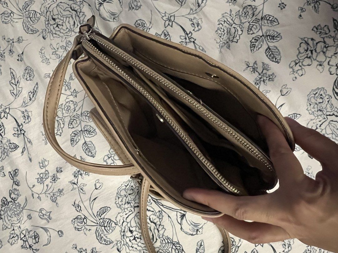 Nine West Crossbody Bag Beige (Category: Cross-body Bags) located in Quezon City. Submitted by spontaneousgrace (Listing ID 1422815385, Image 2). Description: Nine West crossbody bag - Neutral beige color - Multiple compartments with zipper closures - Magnetic snap closure - Adjustable shoulder strap - Interior pockets for organization - Nine West branded tag Condition: Used. See actual photos.