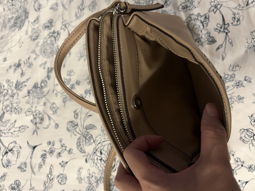 Nine West Crossbody Bag Beige (Category: Cross-body Bags) located in Quezon City. Submitted by spontaneousgrace (Listing ID 1422815385, Image 3). Description: Nine West crossbody bag - Neutral beige color - Multiple compartments with zipper closures - Magnetic snap closure - Adjustable shoulder strap - Interior pockets for organization - Nine West branded tag Condition: Used. See actual photos.