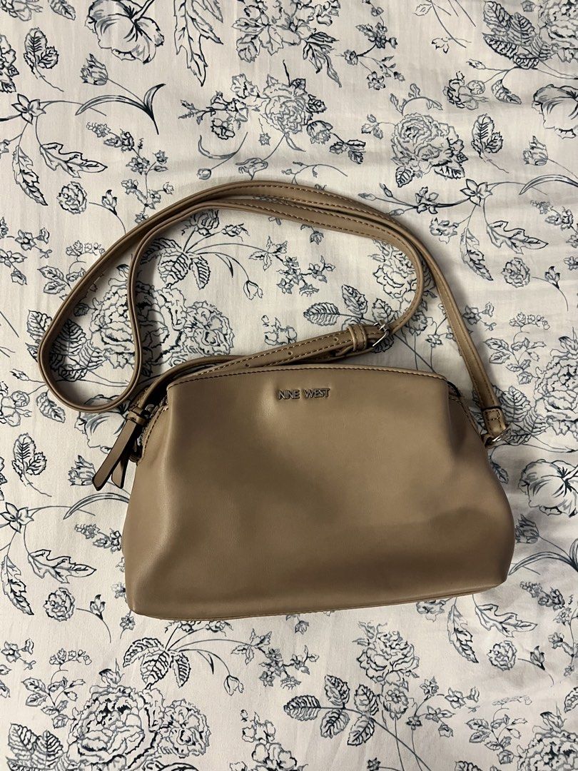 Nine West Crossbody Bag Beige (Category: Cross-body Bags) located in Quezon City. Submitted by spontaneousgrace (Listing ID 1422815385, Image 1). Description: Nine West crossbody bag - Neutral beige color - Multiple compartments with zipper closures - Magnetic snap closure - Adjustable shoulder strap - Interior pockets for organization - Nine West branded tag Condition: Used. See actual photos.