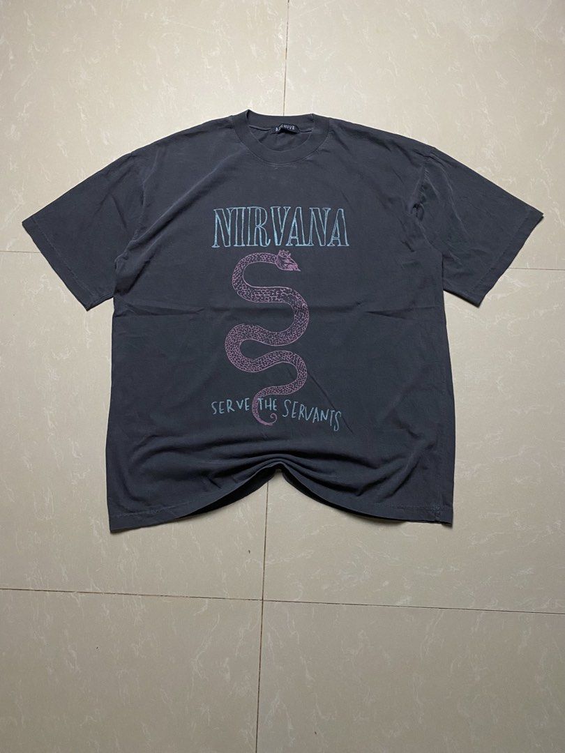 Nirvana Serve the Servants Graphic Tee (Category: Tshirts & Polo Shirts ) located in Manila. Submitted by maikeygong (Listing ID 1422790363, Image 1). Description: - Nirvana graphic tee - Dark gray color - Features a snake design - Includes the band's name and "Serve the Servants" phrase - Standard crew neck - Short sleeves - Made of soft material - Slightly faded look - Size xlarge 22 x 29 - No issues .