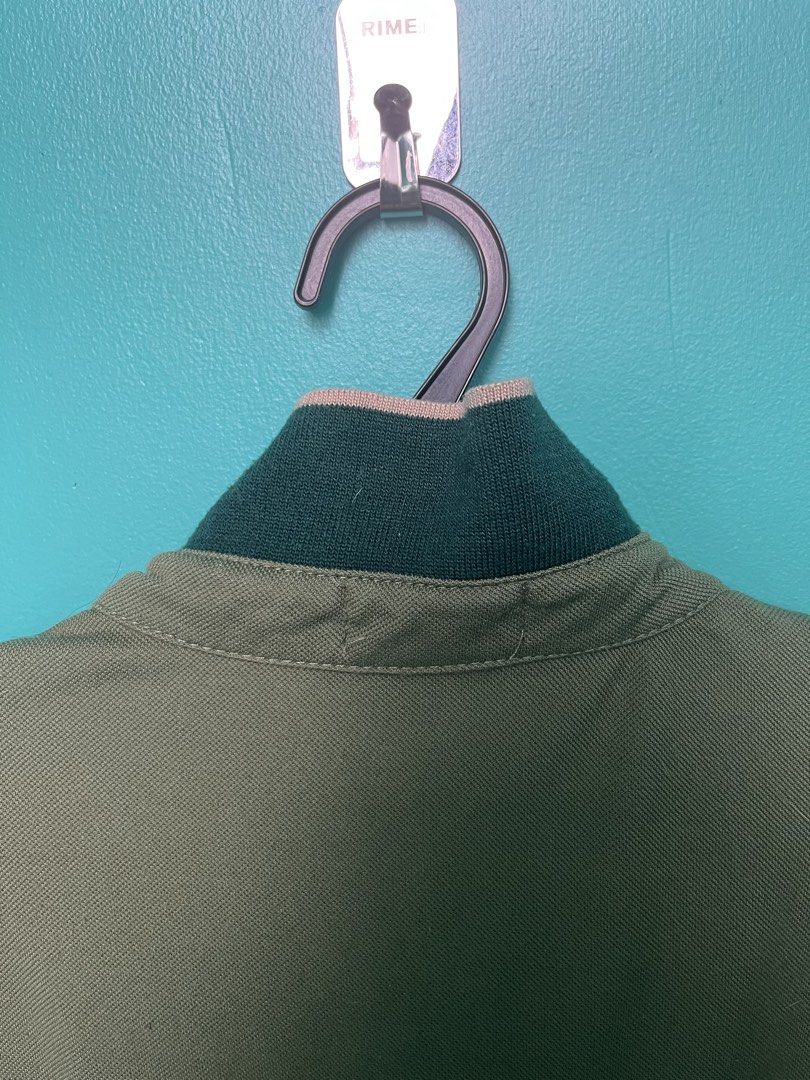 Oscar Polo Shirt - Olive Green (Category: Tshirts & Polo Shirts ) located in Pasay City. Submitted by godiii (Listing ID 1422797499, Image 3). Description: - Oscar polo shirt - Color: Olive green - Size: M - Contrasting collar with striped detailing - Contrasting trim on short sleeves - Button-up placket - Brand label visible.