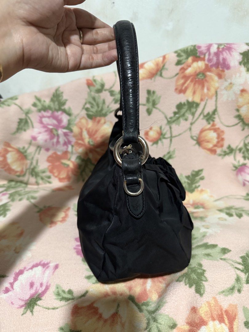 Prada handbag nylon bag (Category: Luxury Bags & Wallets) located in San Pablo. Submitted by prelovedbymistyblue (Listing ID 1422831299, Image 3). Description: Authentic Prada nylon handbag, kili bag. With fading on the hardware. The leather part on the handle has some hardening. With rubber lining issue on the leather part which holds the handle. Riri zipper, with white tag. Missing puller on inner pocket. Selling low for 6500, down to 6000. for